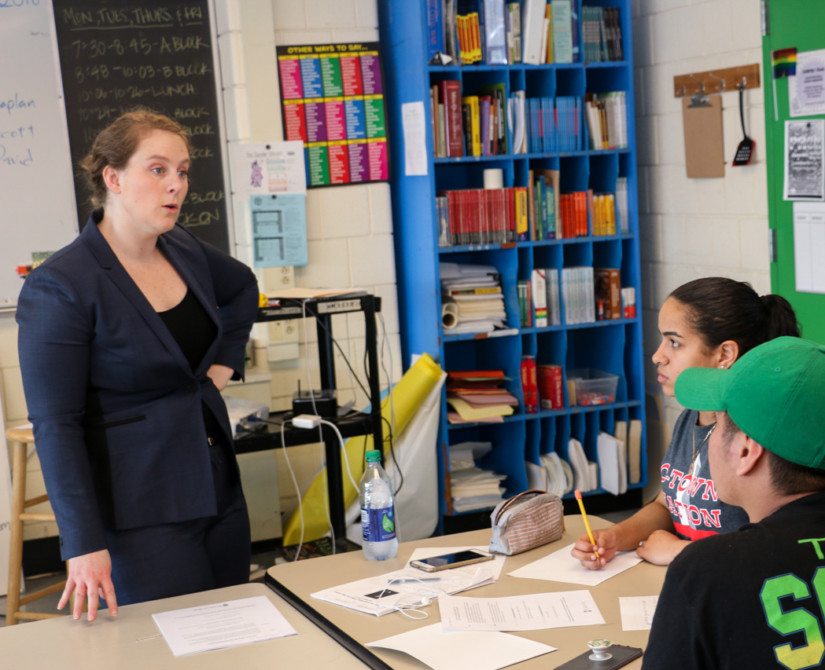 A woman speaking to students in a classroom.